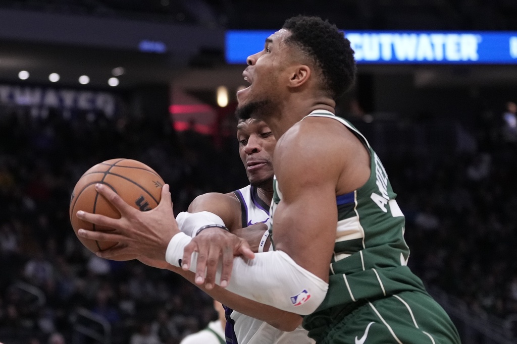 Sacramento Kings' Russell Westbrook fouls Milwaukee Bucks' Giannis Antetokounmpo during the second half of an NBA basketball game Saturday, Nov. 1, 2025, in Milwaukee. (AP Photo/Morry Gash)