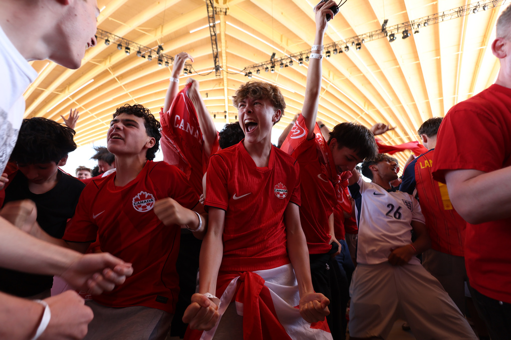 Chase Speed, center, celebrates at watch party, Friday, June 12, 2026, in Vancouver, British Columbia, after Canada scored a goal in the World Cup Group B soccer match between Canada and Bosnia. (AP Photo/Kaleb Tatum)