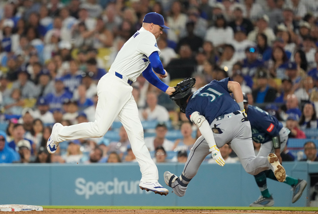 Los Angeles Dodgers first baseman Freddie Freeman, left, tags out Seattle Mariners' Pete Woodworth at first during the sixth inning of a baseball game Thursday, July 30, 2026, in Los Angeles. (AP Photo/Mark J. Terrill)
