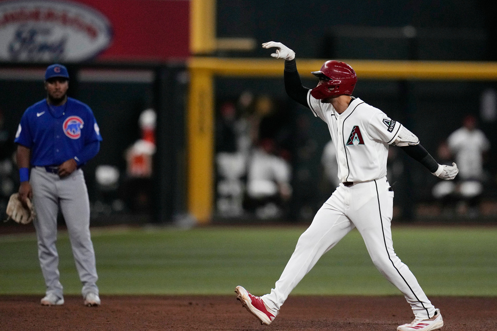Arizona Diamondbacks' Jordan Lawlar, right, celebrates his home run as he runs past Chicago Cubs third baseman Pedro Ramírez, left, during the sixth inning of a baseball game, Wednesday, Aug. 26, 2026, in Phoenix. (AP Photo/Ross D. Franklin)