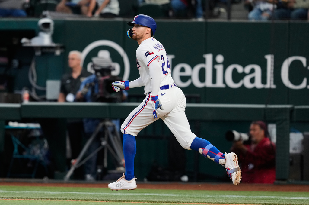 Texas Rangers' Brandon Nimmo sprints out of the batters box watching his fly out to center in the second inning of a baseball game against the New York Yankees Wednesday, April 29, 2026, in Arlington, Texas. (AP Photo/Tony Gutierrez)