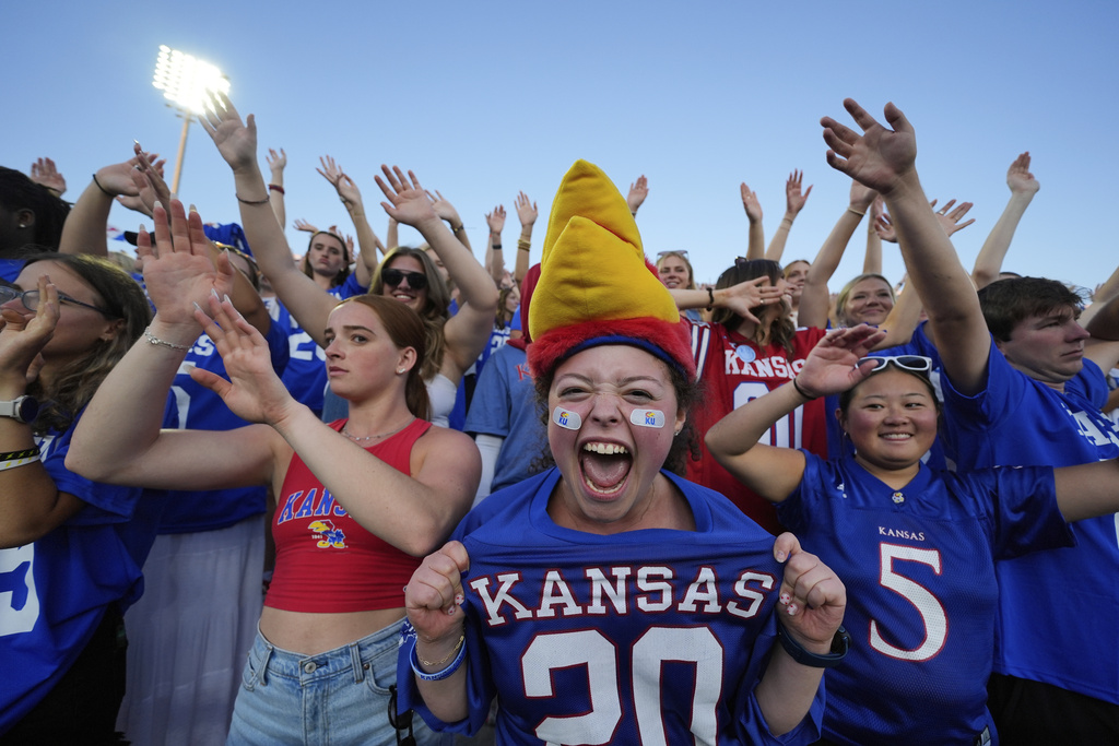 Fans cheer after a Kansas touchdown during the second half of an NCAA college football game against Fresno State Saturday, Aug. 23, 2025, in Lawrence, Kan. (AP Photo/Charlie Riedel)