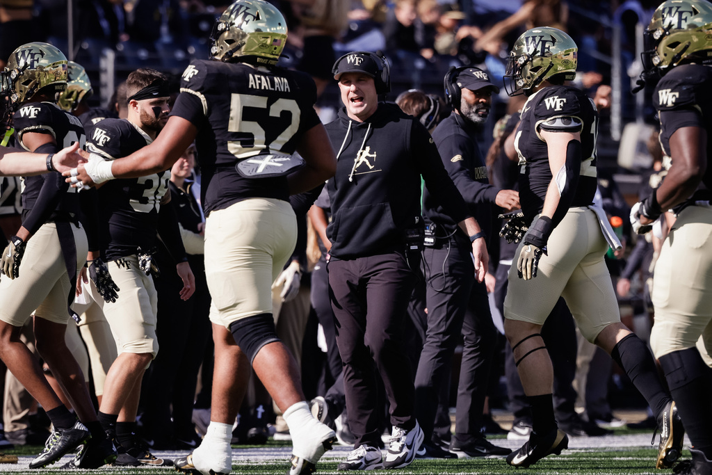 Wake Forest head coach Jake Dickert speaks with his players during the first half of an NCAA football game against Deleware, Saturday, Nov. 22, 2025, in Winston-Salem, N.C. (Allison Lee Isley/The Winston-Salem Journal via AP)