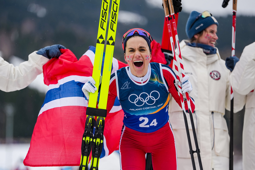 Heidi Weng, of Norway, celebrates after winning the gold medal in the cross country skiing women's 4 x 7.5km relay at the 2026 Winter Olympics, in Tesero, Italy, Saturday, Feb. 14, 2026. (AP Photo/Matthias Schrader)
