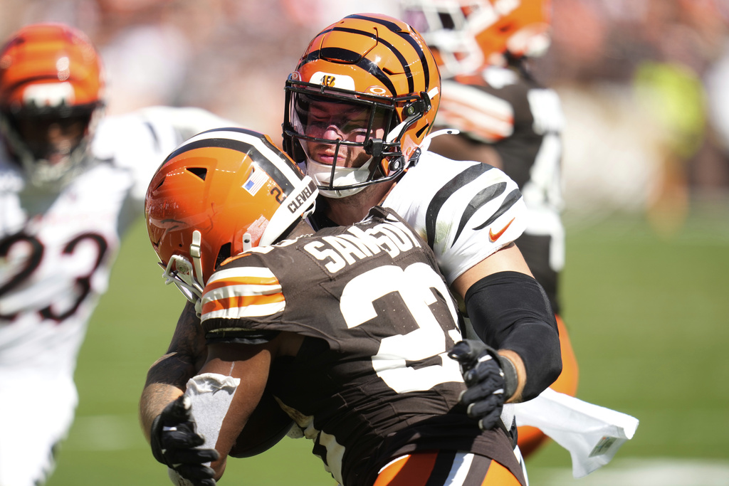 Cincinnati Bengals linebacker Logan Wilson, top, tackles Cleveland Browns running back Dylan Sampson (22) during the second half of an NFL football game Sunday, Sept. 7, 2025, in Cleveland. (AP Photo/Sue Ogrocki)