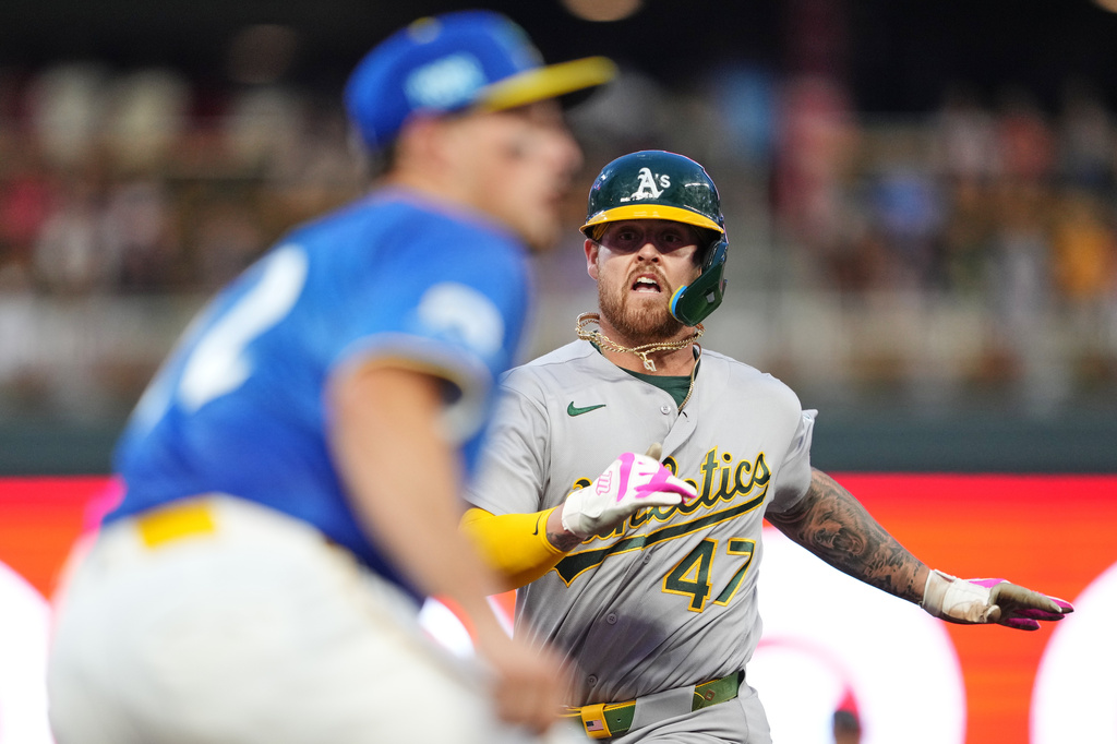 Athletics' Tommy White (47) races to third base before getting tagged out at home late during the fifth inning of a baseball game against the Minnesota Twins, Friday, July 24, 2026, in Minneapolis. (AP Photo/Ellen Schmidt)