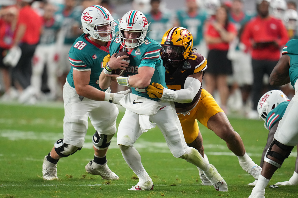 Minnesota defensive lineman Anthony Smith sacks New Mexico quarterback Jack Layne in the first half of a Rate Bowl NCAA college football game, Friday, Dec. 26, 2025, in Phoenix. (AP Photo/Rick Scuteri)