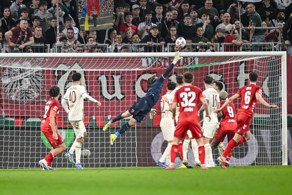 Augsburg goalkeeper Finn Dahmen clears header over the bar during a Bundesliga soccer match between FC Augsburg and 1. FC Cologne, Friday, Feb. 27, 2026, n Augsburg, Germany. (Harry Langer/dpa via AP)