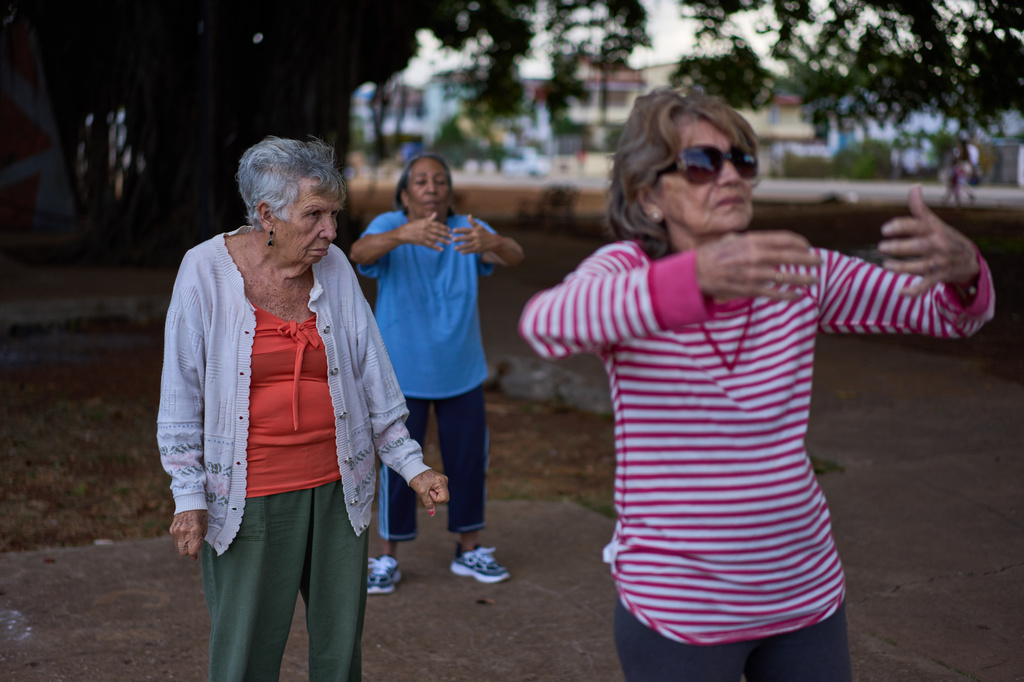 Maribel Ezcurra, 77, a retired milling machine mechanic, practices tai chi with fellow seniors in a park in the Playa neighborhood of Havana, Cuba, Wednesday, April 15, 2026. (AP Photo/Ramon Espinosa)
