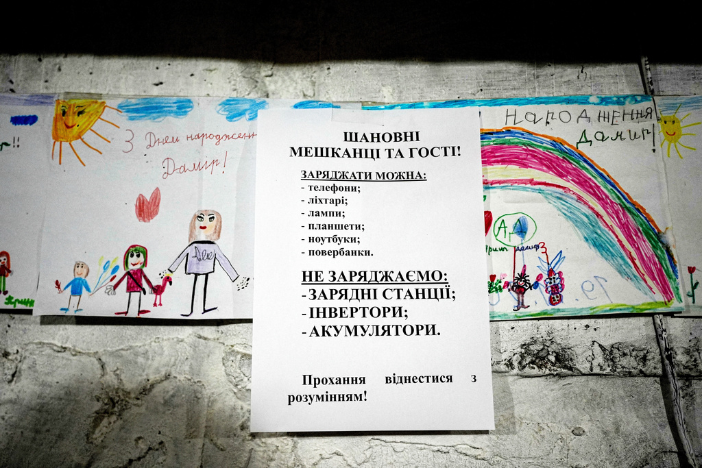 A piece of paper in an underground shelter explains what devices can and can't be charged, during a rolling blackout, Thursday, Oct. 16, 2025, in Shostka, Ukraine. (AP Photo/Julia Demaree Nikhinson)