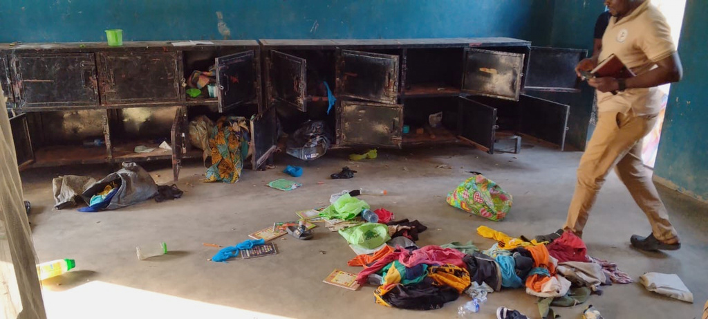 In this photo released by Christian Association of Nigeria, a man walk past belongings at the St. Mary's Catholic Primary and Secondary School after gunmen abducted children and staff in Papiri community, Nigeria, Friday, Nov. 21, 2025. (Christian Association of Nigeria via AP)
