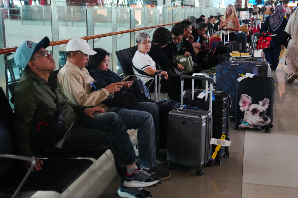 Travelers wait for their flights at Soekarno-Hatta International Airport in Tangerang, Indonesia, Sunday, Sept. 6, 2026. (AP Photo/Tatan Syuflana)