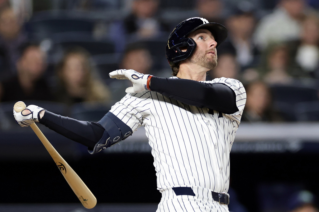 New York Yankees' Ryan McMahon watches his grand slam during the third inning of a baseball game against the Tampa Bay Rays, Wednesday, Sept. 23, 2026, in New York. (AP Photo/Adam Hunger)