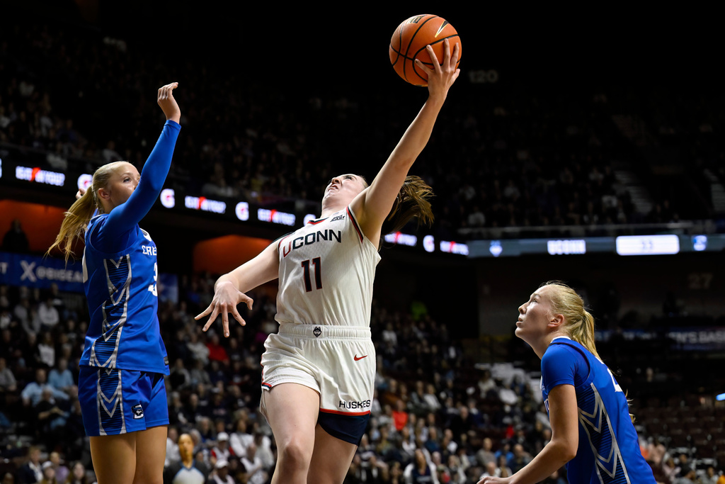UConn guard Allie Ziebell goes up for a basket between Creighton guard Norah Gessert, left, and Creighton guard Ava Zediker during first half of an NCAA college basketball game in the semifinals of the Big East tournament, Sunday, March 8, 2026, in Uncasville, Conn. (AP Photo/Jessica Hill)