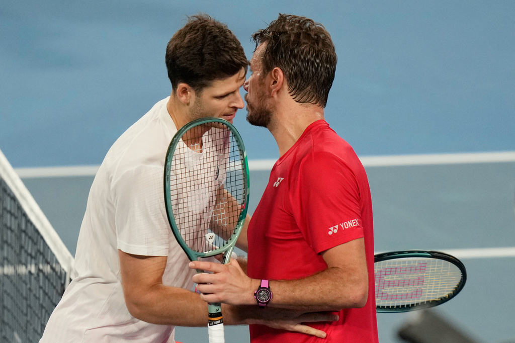 Hubert Hurkacz of Poland, left, and Stan Wawrinka of Switzerland meet at the net after Hurkacz won their final match at the United Cup tennis tournament in Sydney, Sunday, Jan. 11, 2026. (AP Photo/Rick Rycroft)
