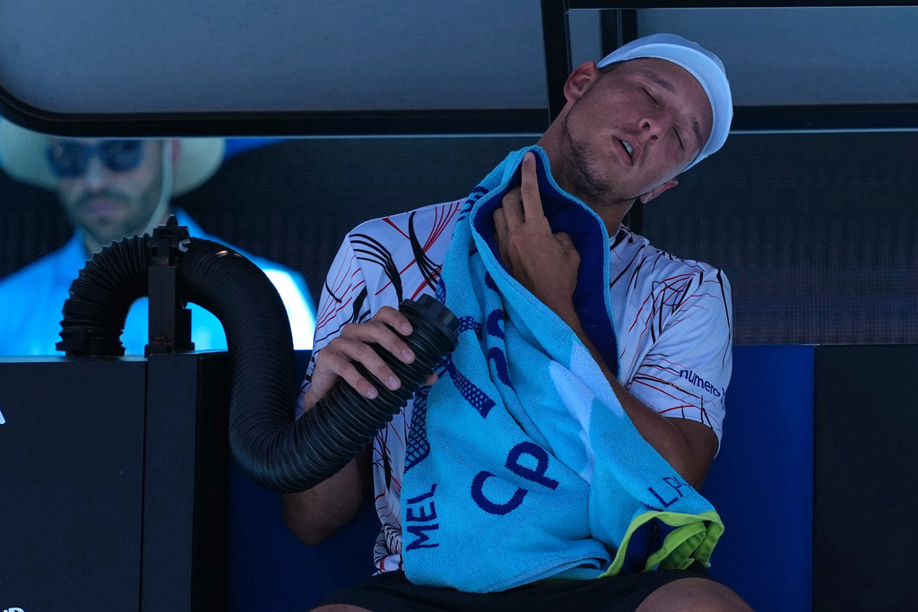 Luciano Darderi of Italy cools himself during a break in his third round match against Karen Khachanov of Russia at the Australian Open tennis championship in Melbourne, Australia, Saturday, Jan. 24, 2026. (AP Photo/Dar Yasin)