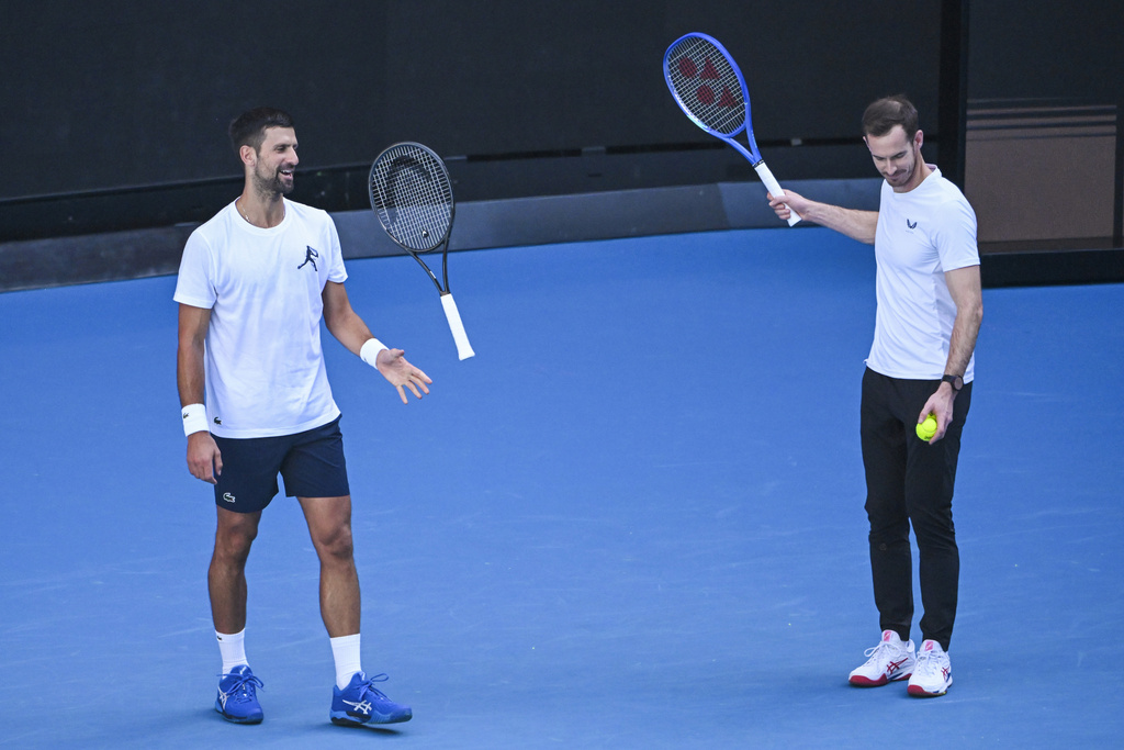 Novak Djokovic of Serbia, left, and coach Andy Murray react during a training session ahead of the Australian Open tennis tournament at Melbourne Park in Melbourne, Tuesday, Jan. 7, 2025. (James Ross/AAP Image via AP)