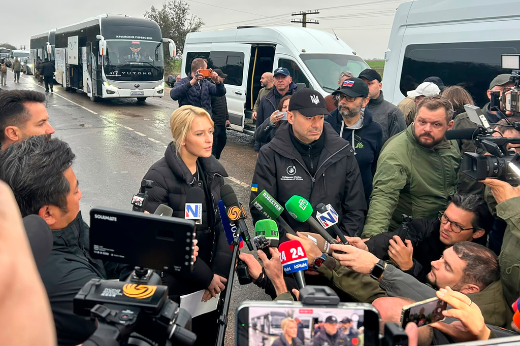 In this photo provided by the Office of the Ombudsman of Ukraine, Ukraine's Ombudsman Dmytro Lubinets, center right, and Russian Ombudsman Yana Lantratova speak with journalists before departing for Oleshky to evacuate local residents to a safe area during a local ceasefire linked to a humanitarian mission in Ukraine's Kherson region, Friday, Oct. 30, 2026. (Office of the Ombudsman of Ukraine via AP) CORRECTION: change position of Dmytro Lubinets from center left to center right
