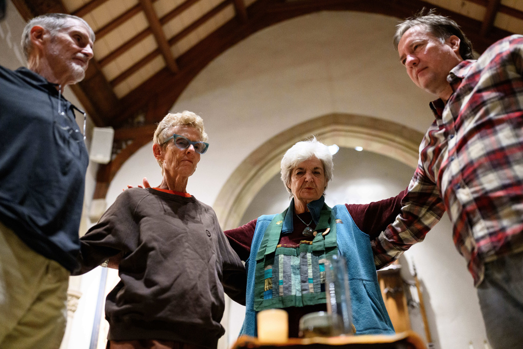 Participants form a circle to end an interfaith meditation practice at All Saints Episcopal Church in Pasadena, Calif., on Monday, Dec. 15, 2025. (AP Photo/William Liang)