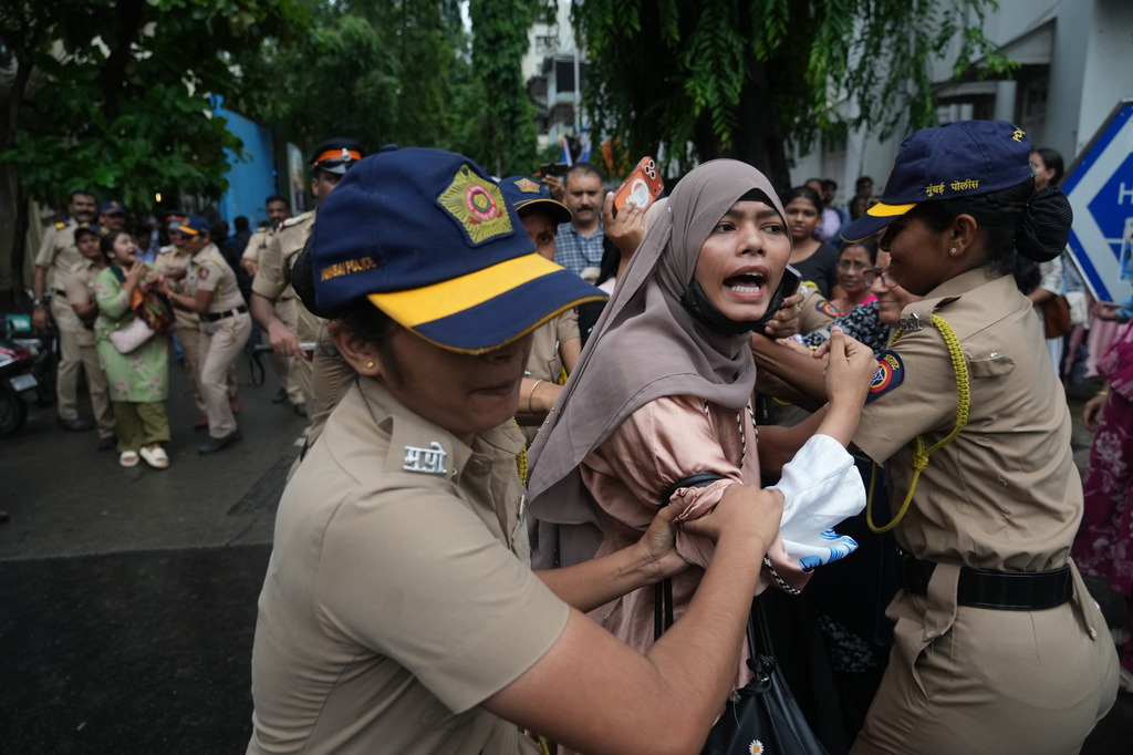 Police officers detain supporters of the Cockroach Janta Party during a protest demanding the resignation of India's education minister in Mumbai, India, Monday, July 20, 2026. (AP Photo/Rafiq Maqbool)