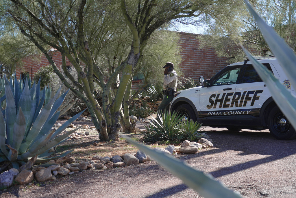 A Pima County sheriffs official stays outside of Nancy Guthrie‘s home on Saturday, Feb. 14, 2026 in Tucson, Ariz. (AP Photo/Ty O'Neil)