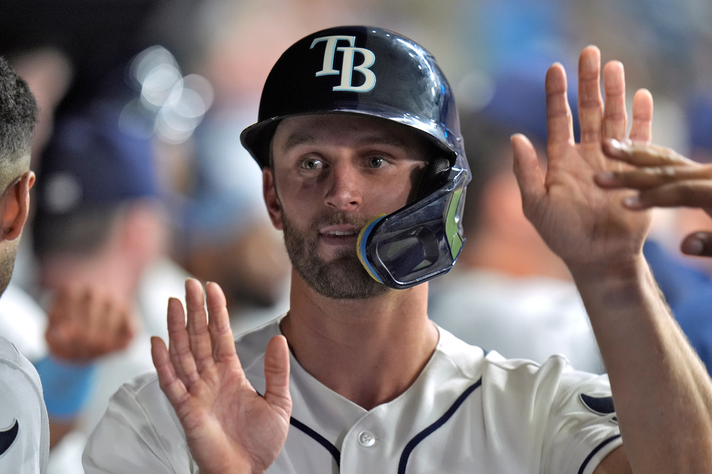 Tampa Bay Rays' Kenny Piper celebrates in the dugout after scoring on a sacrifice fly by Nick Madrigal off Houston Astros pitcher Bennett Sousa during the seventh inning of a baseball game Saturday, Sept. 12, 2026, in St. Petersburg, Fla. (AP Photo/Chris O'Meara)