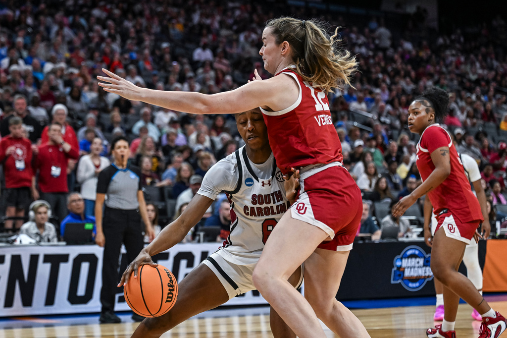 South Carolina forward Joyce Edwards, center left, dribbles against Oklahoma guard Payton Verhulst, center right, during the first half in the Sweet 16 of the NCAA college basketball tournament Saturday, March 28, 2026, in Sacramento, Calif. (AP Photo/Justine Willard)