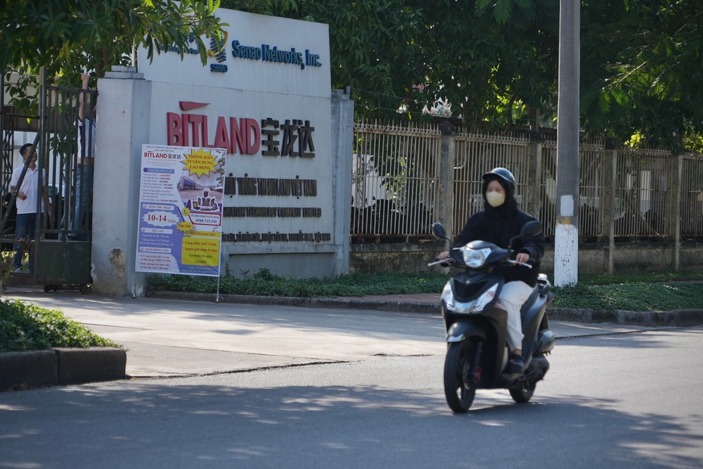 A woman rides past a recruitment poster outside a company at Tien Son Industrial Park in Bac Ninh province, Vietnam, on Dec. 26, 2025. (AP Photo/Hau Dinh)