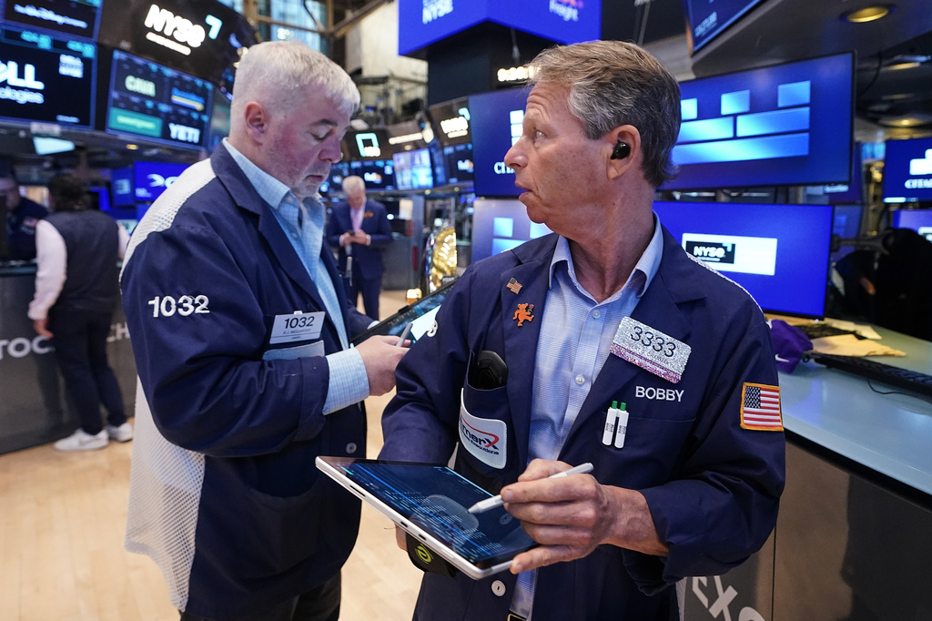 Traders Edward McCarthy, left, and Robert Charmak work on the floor of the New York Stock Exchange, Monday, June 1, 2026. (AP Photo/Richard Drew)