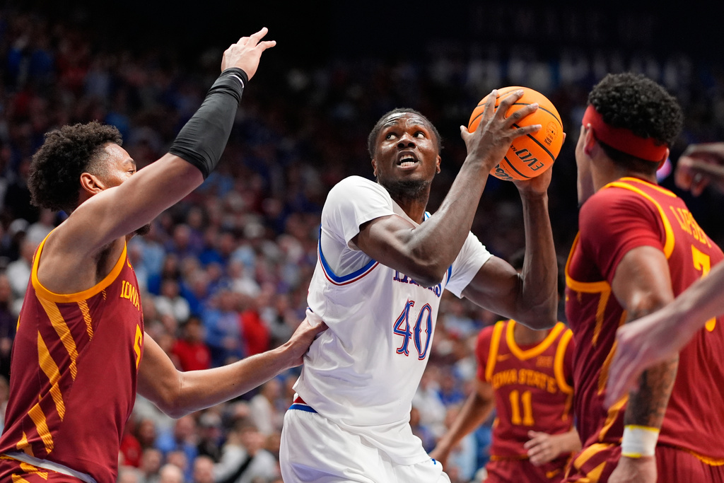 Kansas forward Flory Bidunga (40) looks to shoot over Iowa State forward Joshua Jefferson, left, during the first half of an NCAA college basketball game Tuesday, Jan. 13, 2026, in Lawrence, Kan. (AP Photo/Charlie Riedel)
