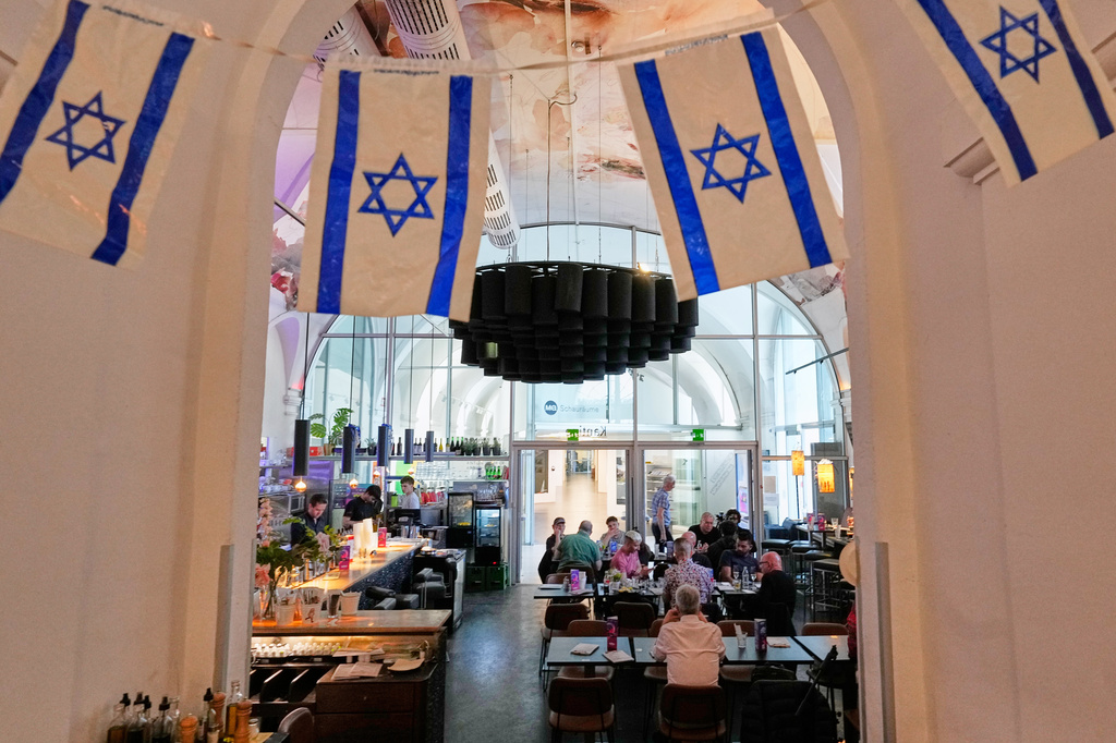 Israeli flags hang in the designated Israel "Euro Cafe" MQ Kantine during the 70th Eurovision Song Contest week in Vienna, Austria, Wednesday, May 13, 2026. (AP Photo/Martin Meissner)
