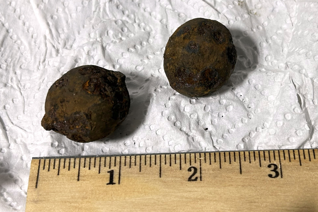 This photo provided by the Transportation Security Administration (TSA) shows two stolen Civil War-era cannonballs discovered by TSA officers in a checked bag at the Gulf Shores International Airport in Gulf Shores, Ala., on July 18, 2026. (Transportation Security Administration via AP)
