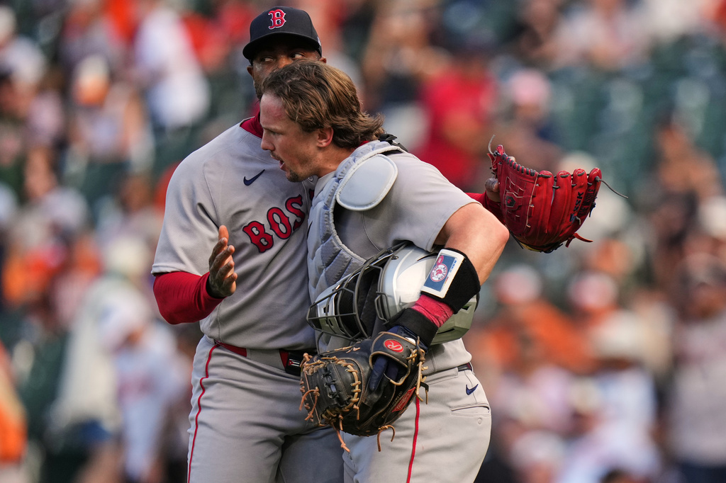 Boston Red Sox pitcher Aroldis Chapman, left, and catcher Adley Rutschman, right, celebrate after their team's victory over the Baltimore Orioles in a baseball game, Sunday, Sept. 6, 2026, in Baltimore. (AP Photo/Stephanie Scarbrough)