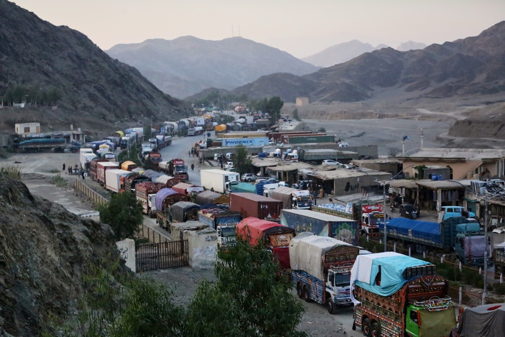 A line of cargo trucks bound for Pakistan is stranded on the Afghan side of the Torkham border crossing, which remained closed after clashes, in Nangarhar province, Afghanistan, Tuesday, Oct. 14, 2025. (AP Photo/Wahidullah Kakar)