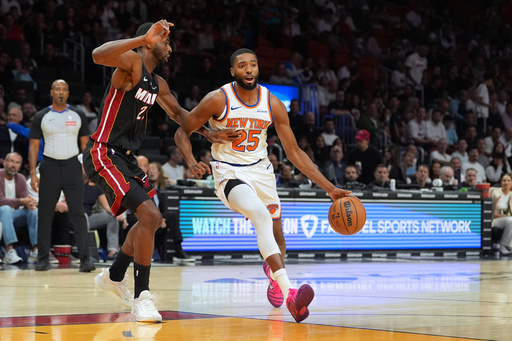 New York Knicks guard Mikal Bridges (25) drives forward defended by Miami Heat forward Andrew Wiggins during the first half of an NBA basketball game, Sunday, Oct. 26, 2025, in Miami. (AP Photo/Rebecca Blackwell) New York Knicks guard Mikal Bridges (25) drives forward defended by Miami Heat forward Andrew Wiggins during the first half of an NBA basketball game, Sunday, Oct. 26, 2025, in Miami. (AP Photo/Rebecca Blackwell)