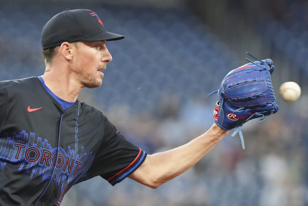 Toronto Blue Jays pitcher Chris Bassitt collects the ball to force out Baltimore Orioles' Gunnar Henderson at first base during first-inning baseball game action in Toronto, Friday, Sept. 12, 2025. (Chris Young/The Canadian Press via AP)