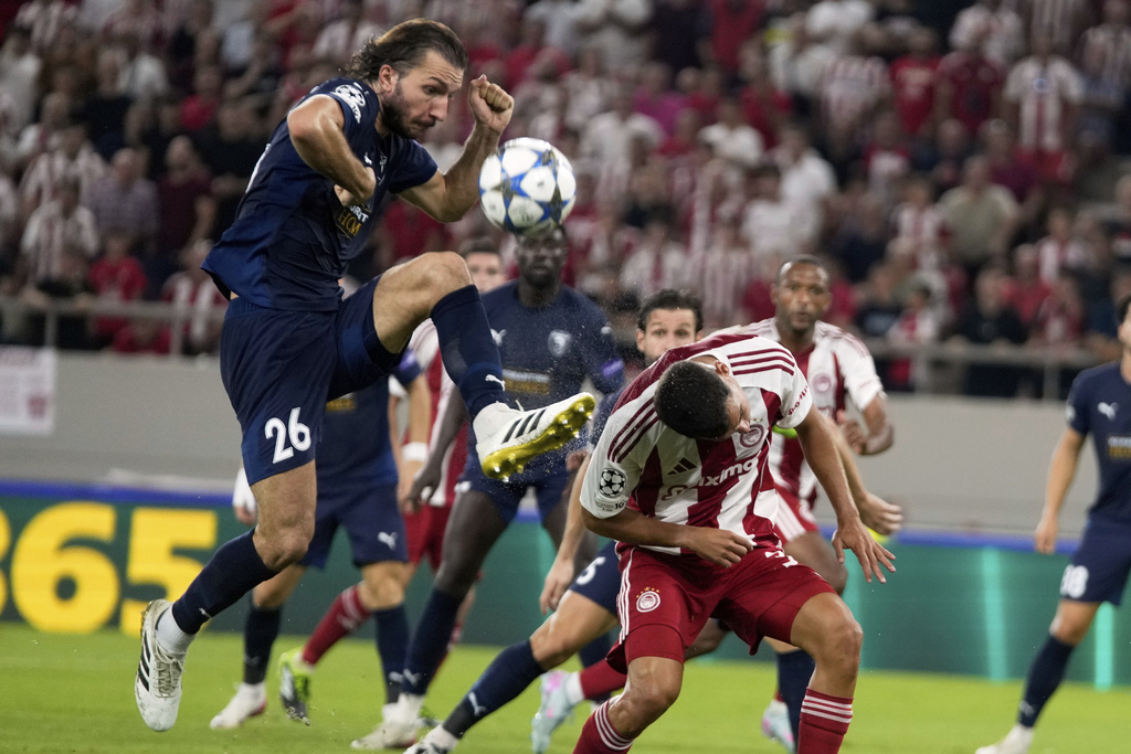 Pafos' Ivan Sunjic fights for the ball against Olympiacos' Francisco Ortega during a Champions League opening phase soccer match between Olympiakos and Pafos at the Georgios Karaiskakis stadium, Piraeus port, near Athens, Greece, Wednesday, Sept. 17, 2025. (AP Photo/Petros Giannakouris)
