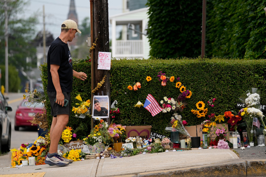 A man pauses to view a makeshift memorial to the victim of a shooting involving U.S. Immigration and Customs Enforcement, Tuesday, July 14, 2026 in Biddeford, Maine. (AP Photo/Robert F. Bukaty)