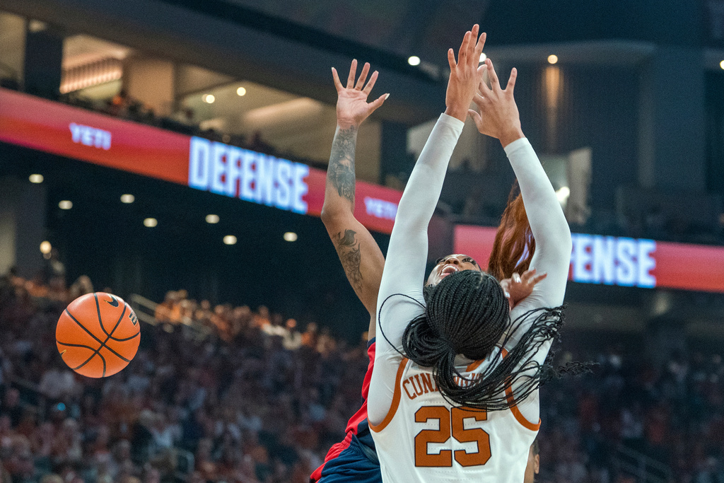 Mississippi forward Cotie McMahon, back, is fouled by Texas forward Breya Cunningham (25) during the first half of an NCAA college basketball game in Austin, Texas, Sunday, Jan. 4, 2026. (AP Photo/Rodolfo Gonzalez)