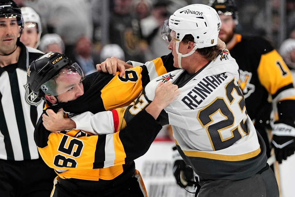 Pittsburgh Penguins' Avery Hayes (85) fights with Vegas Golden Knights' Cole Reinhardt (23) during the second period of an NHL hockey game in Pittsburgh, Sunday, March 1, 2026. (AP Photo/Gene J. Puskar)