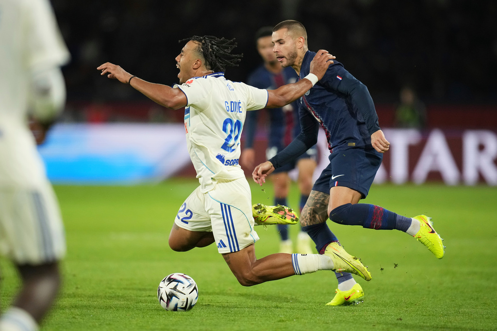 PSG's Lucas Hernandez, right, and Strasbourg's Guela Doue challenge for the ball during the French League One soccer match between Paris Saint-Germain and Strasbourg, in Paris, France, Friday, Oct. 17, 2025. (AP Photo/Christophe Ena)