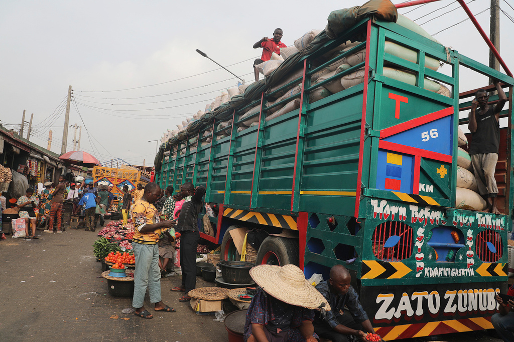 FILE -Workers offload grains from a truck at the Mile 12 Market in Lagos, Nigeria, Feb. 16, 2024. AP Photo/Mansur Ibrahim, File)