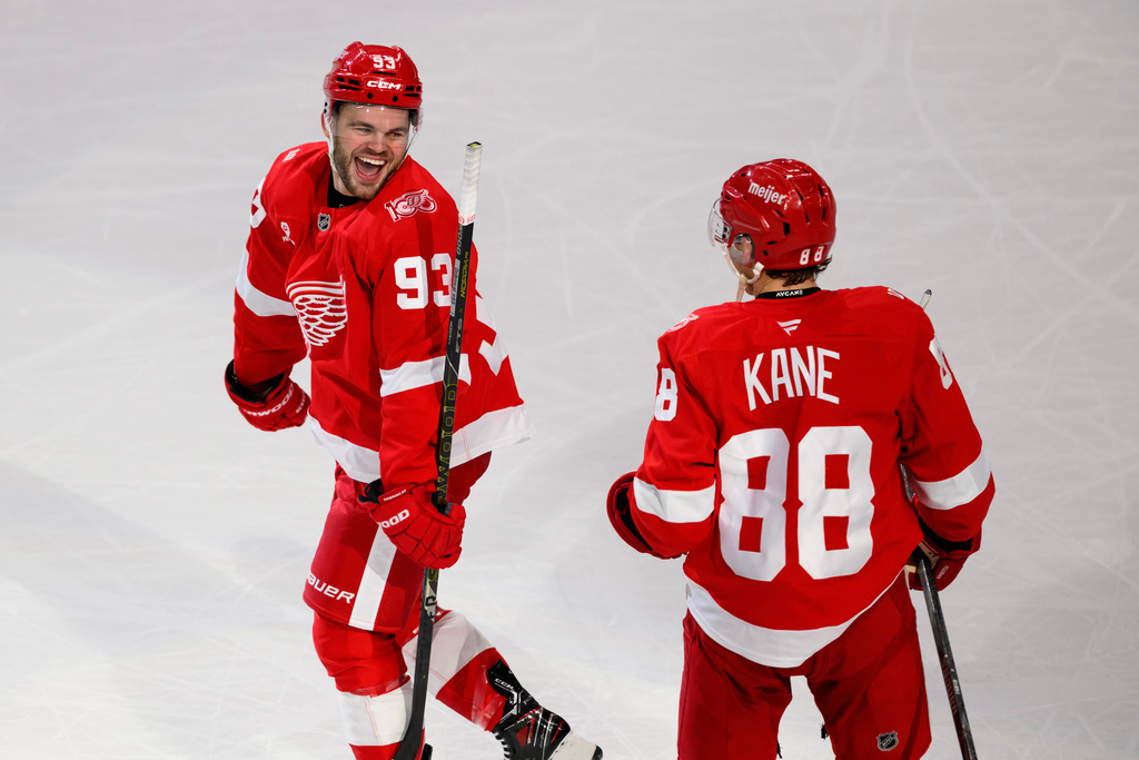 Detroit Red Wings right wing Alex DeBrincat (93) Detroit Red Wings right wing Patrick Kane (88) after scoring the game-winning goal against the Ottawa Senators in overtime of an NHL hockey game, Sunday, Jan. 18, 2026, in Detroit. (AP Photo/Lon Horwedel)