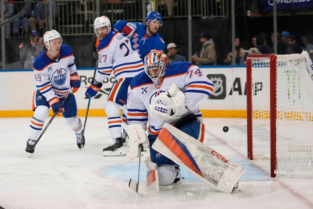 Edmonton Oilers goaltender Stuart Skinner (74) stops a shot during the second period of an NHL hockey game against the New York Rangers Tuesday, Oct. 14, 2025, in New York. (AP Photo/Frank Franklin II)