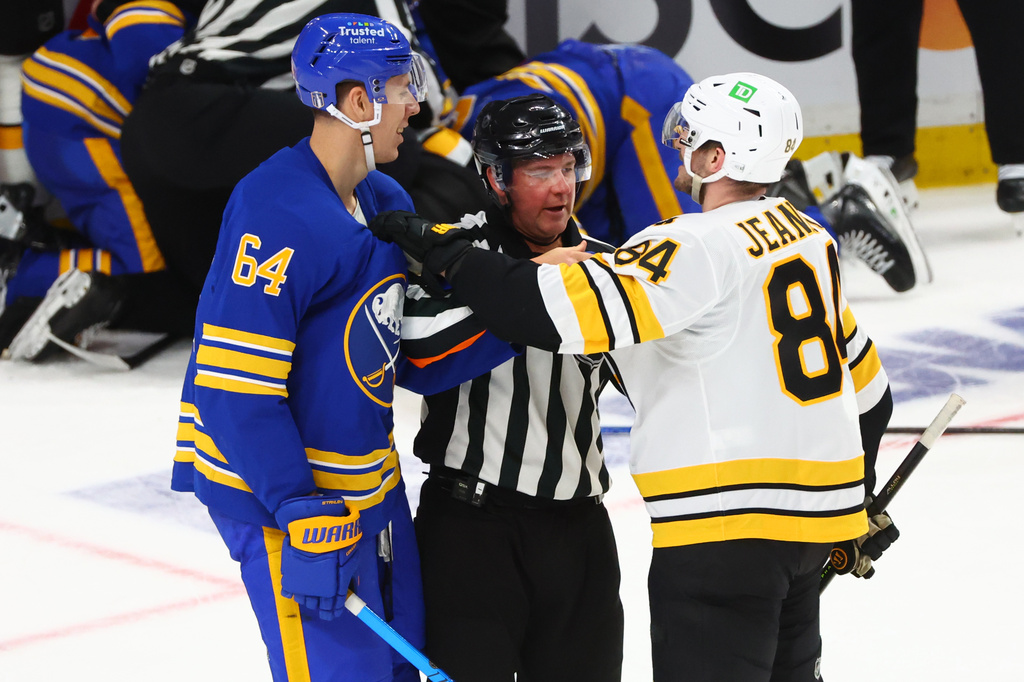 Buffalo Sabres defenseman Logan Stanley (64) and Boston Bruins left wing Tanner Jeannot (84) are separated during the third period in Game 1 of a first-round NHL hockey Stanley Cup playoff series, Sunday, April 19, 2026, in Buffalo, N.Y. (AP Photo/Jeffrey T. Barnes)