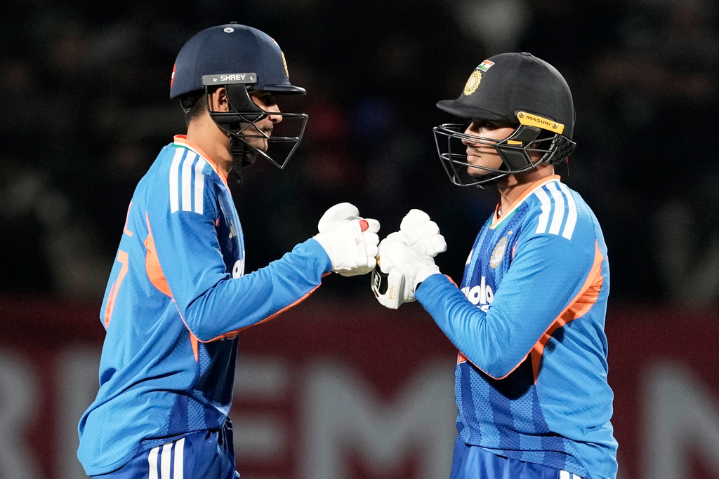India's Shubman Gill, left, and Abhishek Sharma greets each other during the third T20 cricket match between India and South Africa in Dharamshala, India, Sunday, Dec. 14, 2025. (AP Photo/Ashwini Bhatia)