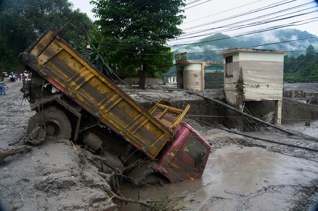 A vehicle is seen in the aftermath of a flash floods in Devighat in the Nuwakot district in Nepal. Thursday, Aug 27, 2026. (AP Photo/Niranjan Shrestha)