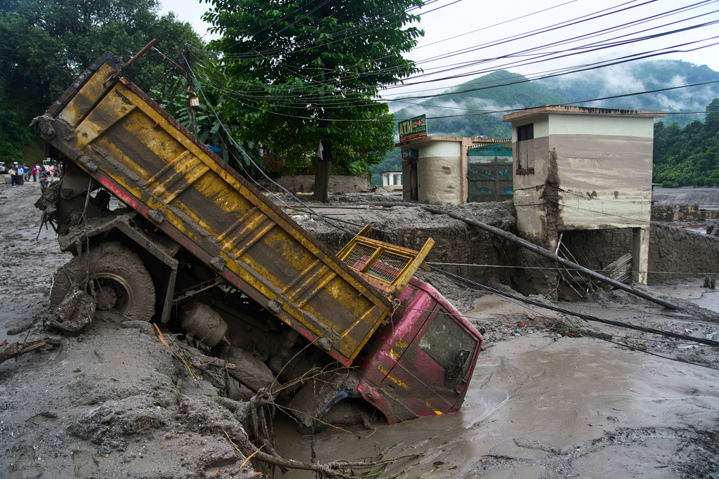 A vehicle is seen in the aftermath of flash floods in Devighat in the Nuwakot district in Nepal, Thursday, Aug. 27, 2026. (AP Photo/Niranjan Shrestha)