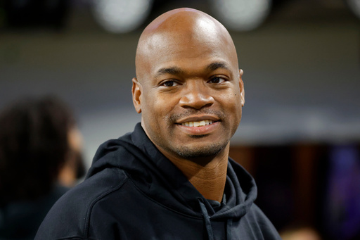 FILE - Former Minnesota Vikings running back Adrian Peterson stands on the field before an NFL football game between the Vikings and the Chicago Bears, Nov. 27, 2023, in Minneapolis. (AP Photo/Bruce Kluckhohn, File) FILE - Former Minnesota Vikings running back Adrian Peterson stands on the field before an NFL football game between the Vikings and the Chicago Bears, Nov. 27, 2023, in Minneapolis. (AP Photo/Bruce Kluckhohn, File)