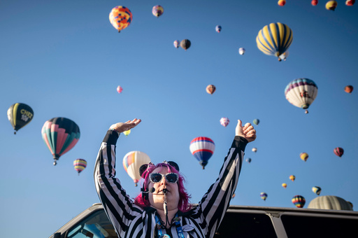 FILE - Launch Director Kat Brennan signals for a pilot to go ahead and take off Oct. 7, 2023, during the Albuquerque International Balloon Fiesta in Albuquerque, N.M. (AP Photo/Roberto E. Rosales, File) FILE - Launch Director Kat Brennan signals for a pilot to go ahead and take off Oct. 7, 2023, during the Albuquerque International Balloon Fiesta in Albuquerque, N.M. (AP Photo/Roberto E. Rosales, File)